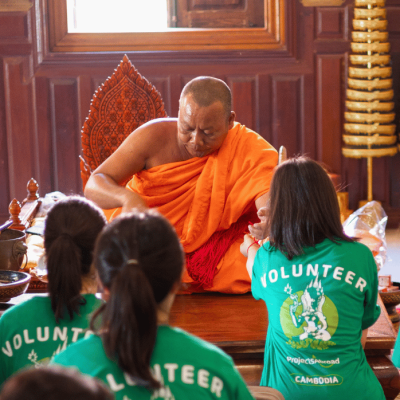 Participants receive a blessing from a priest in Cambodia